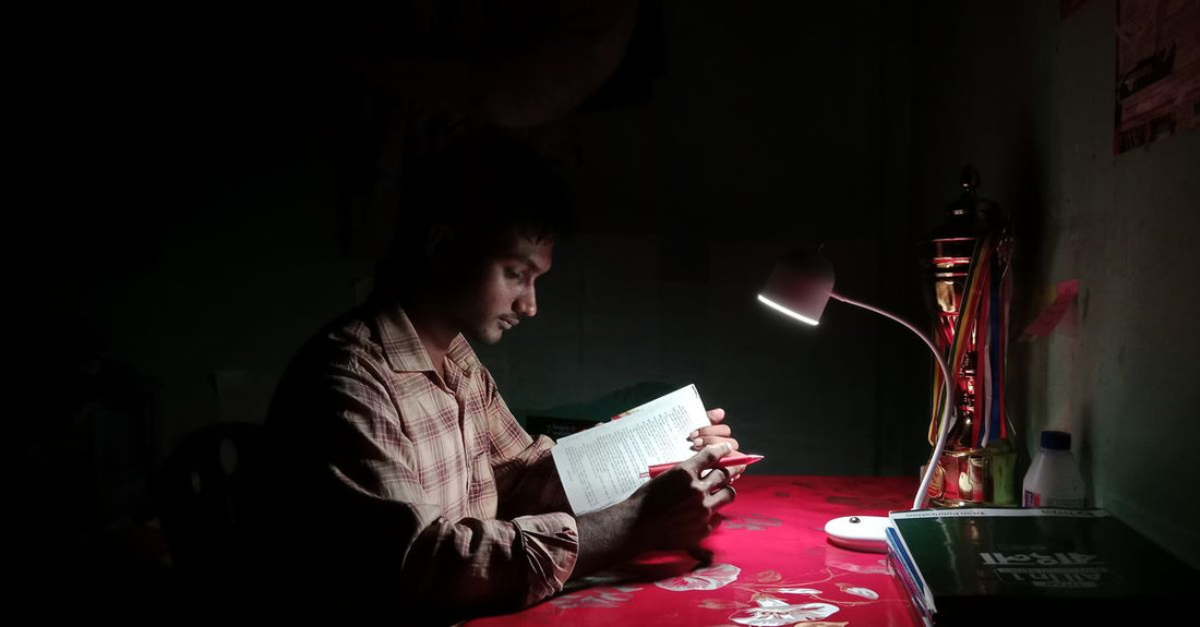 Student studying late at night in a dark room